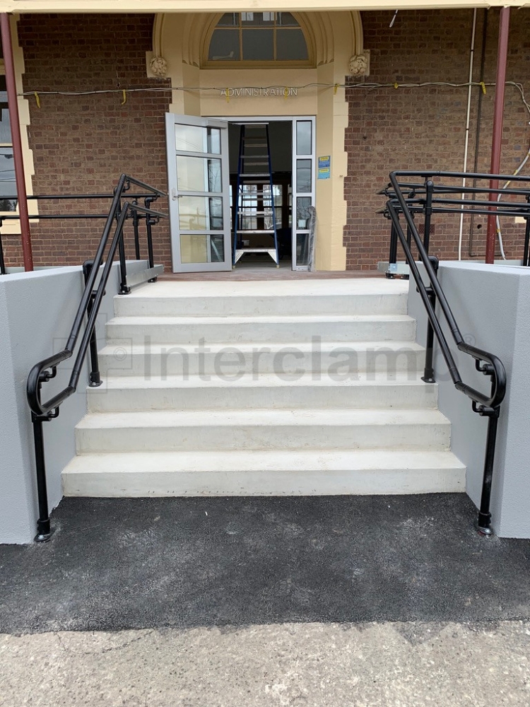 Smooth inline modular handrail system installed on steps to school entrance, Australia